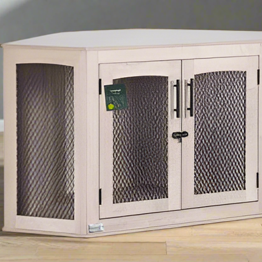 Corner pet crate with mesh doors on a wooden floor against a gray wall