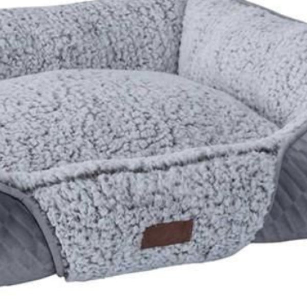 A self-warming grey dog and puppy bed with a label showing the brand Quapas.