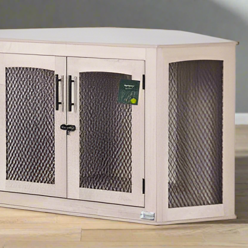 Corner pet crate with mesh doors on a wooden floor against a gray wall