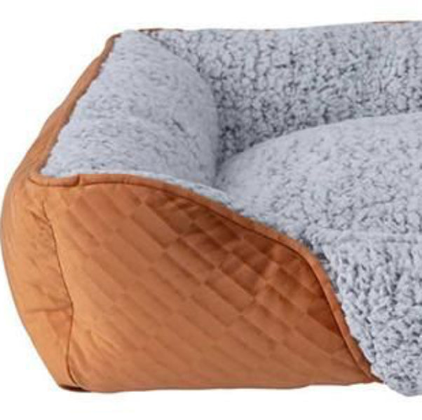 A beige, brown, and gray Quapas self-warming dog bed with a plush design and a visible brand label.
