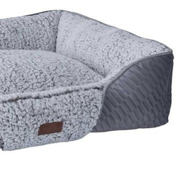 Gray pet bed with a brand label on a white background